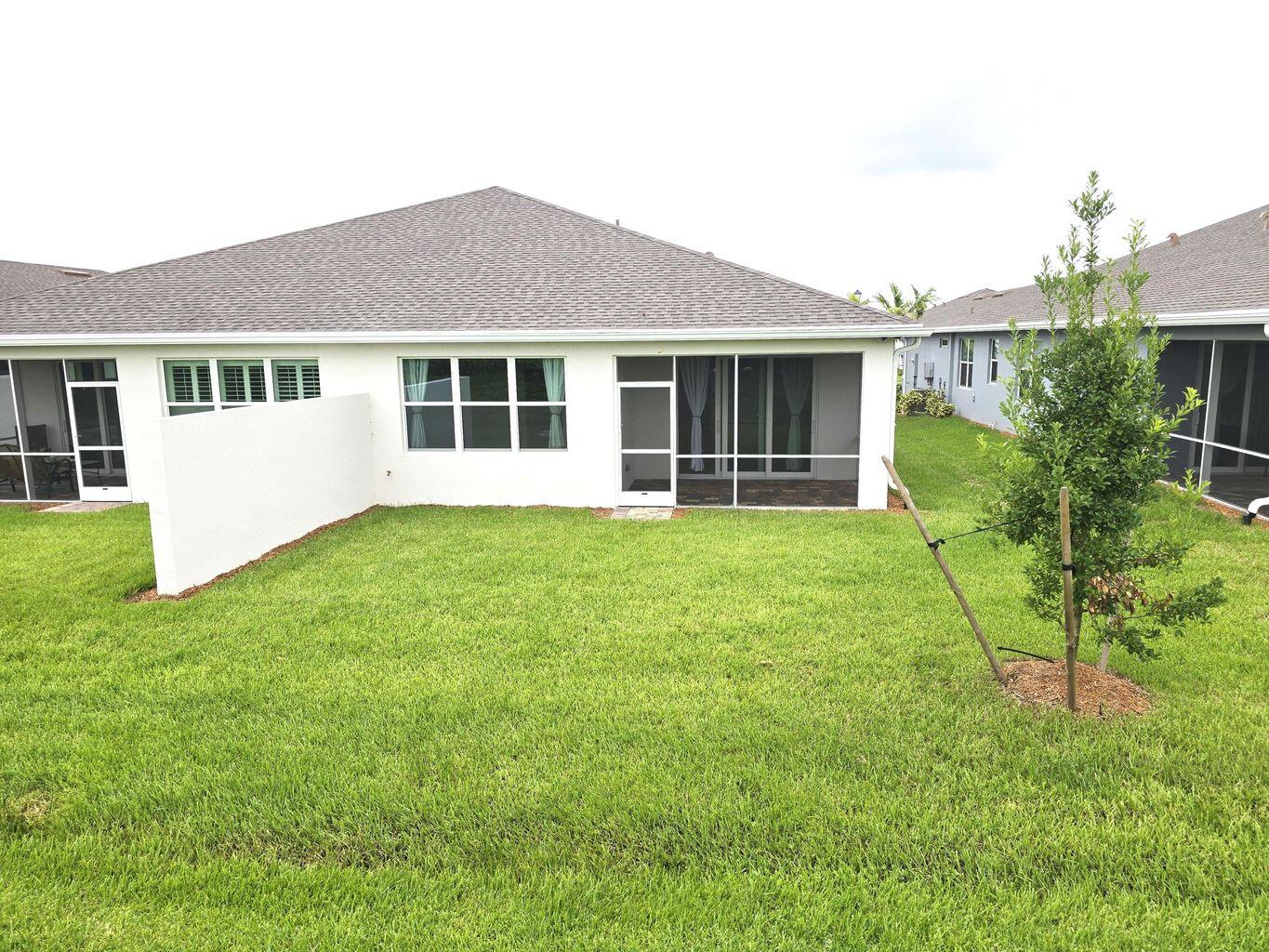 13897 Southwest Gingerline Drive Port St. Lucie, FL 34987 - Photo 6 of 74 a view of a house with a yard and plants