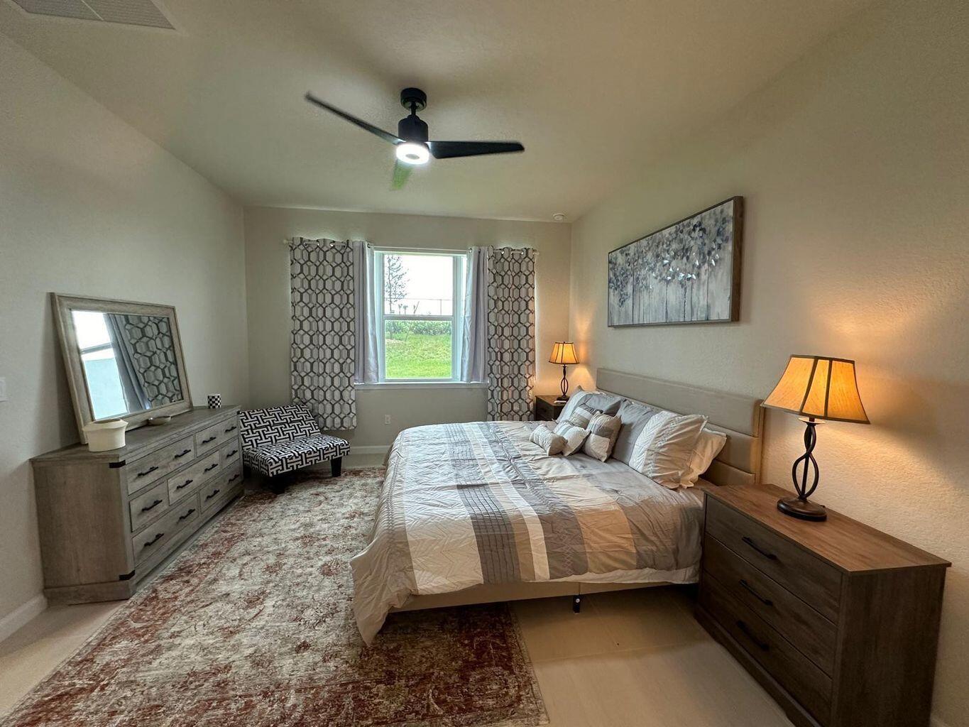 13897 Southwest Gingerline Drive Port St. Lucie, FL 34987 - Photo 61 of 74 a bedroom with a bed and wooden floor