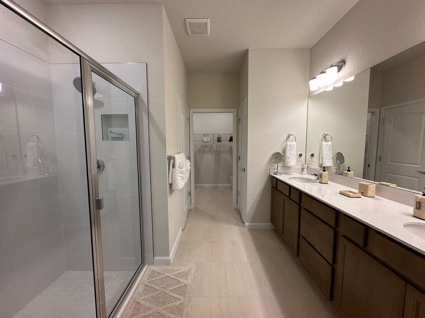 13897 Southwest Gingerline Drive Port St. Lucie, FL 34987 - Photo 64 of 74 a bathroom with a double vanity sink mirror and shower