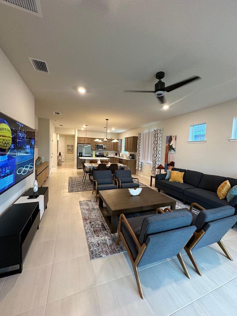 13897 Southwest Gingerline Drive Port St. Lucie, FL 34987 - Photo 8 of 74 a living room with furniture and a flat screen tv