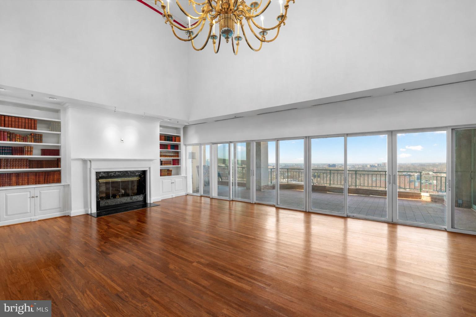 3801 Canterbury Road, Unit 1104 Baltimore, MD 21218 - Photo 4 of 74 a view of an empty room with wooden floor and a fireplace
