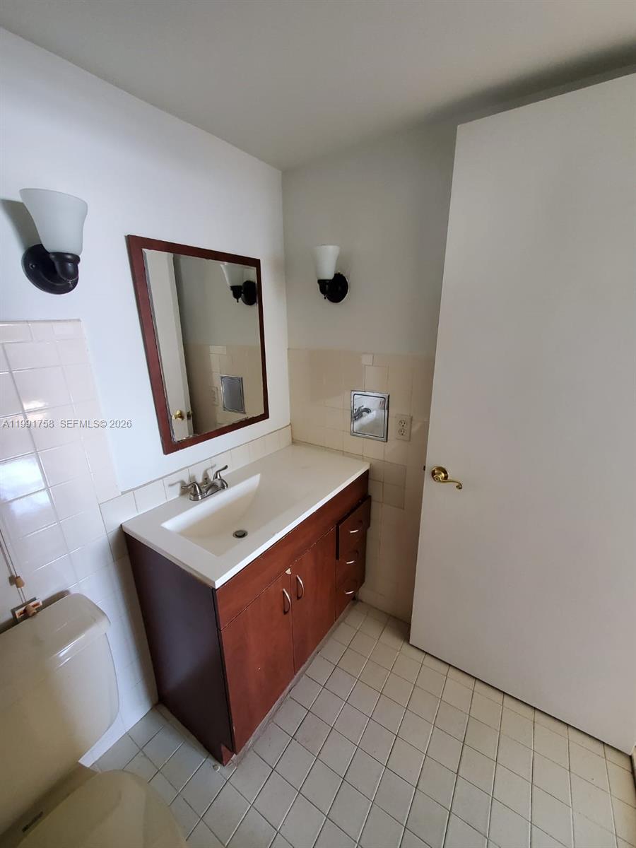 555 Northeast 30th Street, Unit 502 Miami, FL 33137 - Photo 12 of 19 a bathroom with a sink vanity and mirror