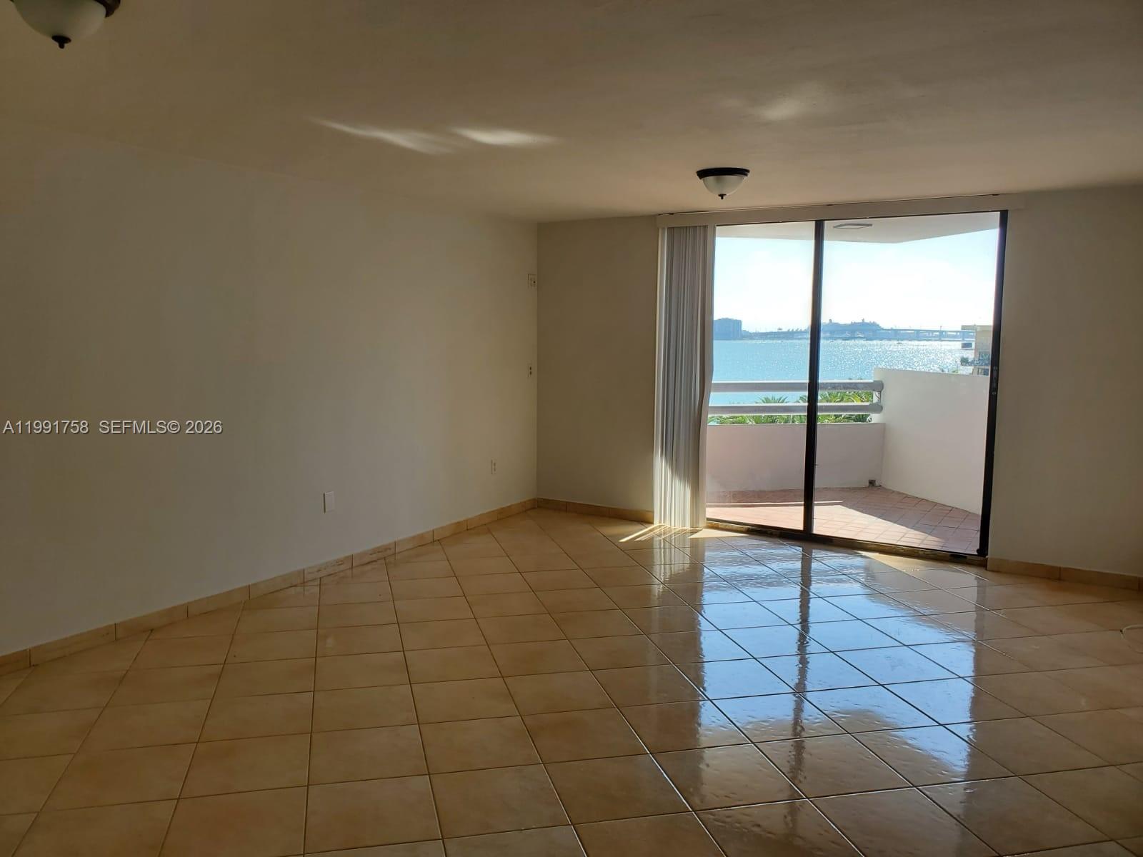 555 Northeast 30th Street, Unit 502 Miami, FL 33137 - Photo 2 of 19 a view of an empty room with glass door