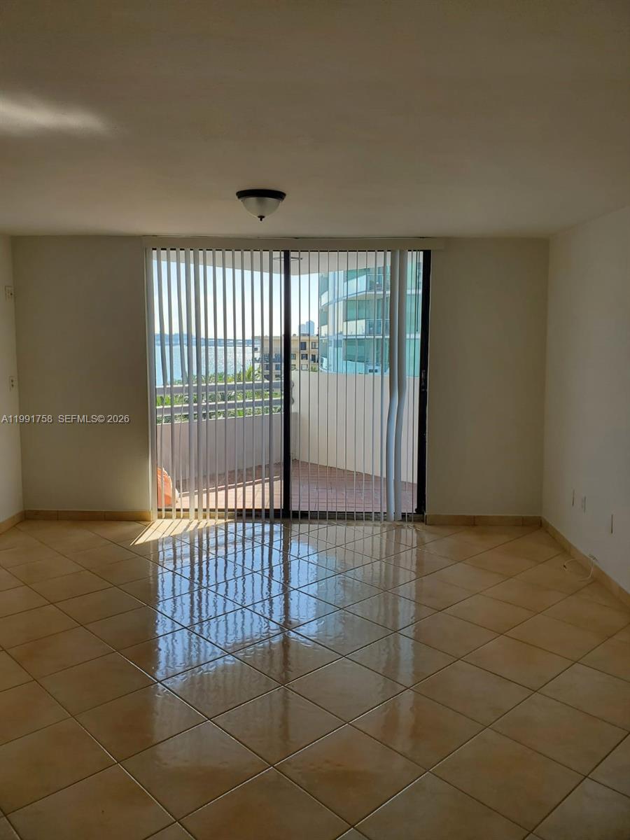 555 Northeast 30th Street, Unit 502 Miami, FL 33137 - Photo 4 of 19 a view of an empty room with a window