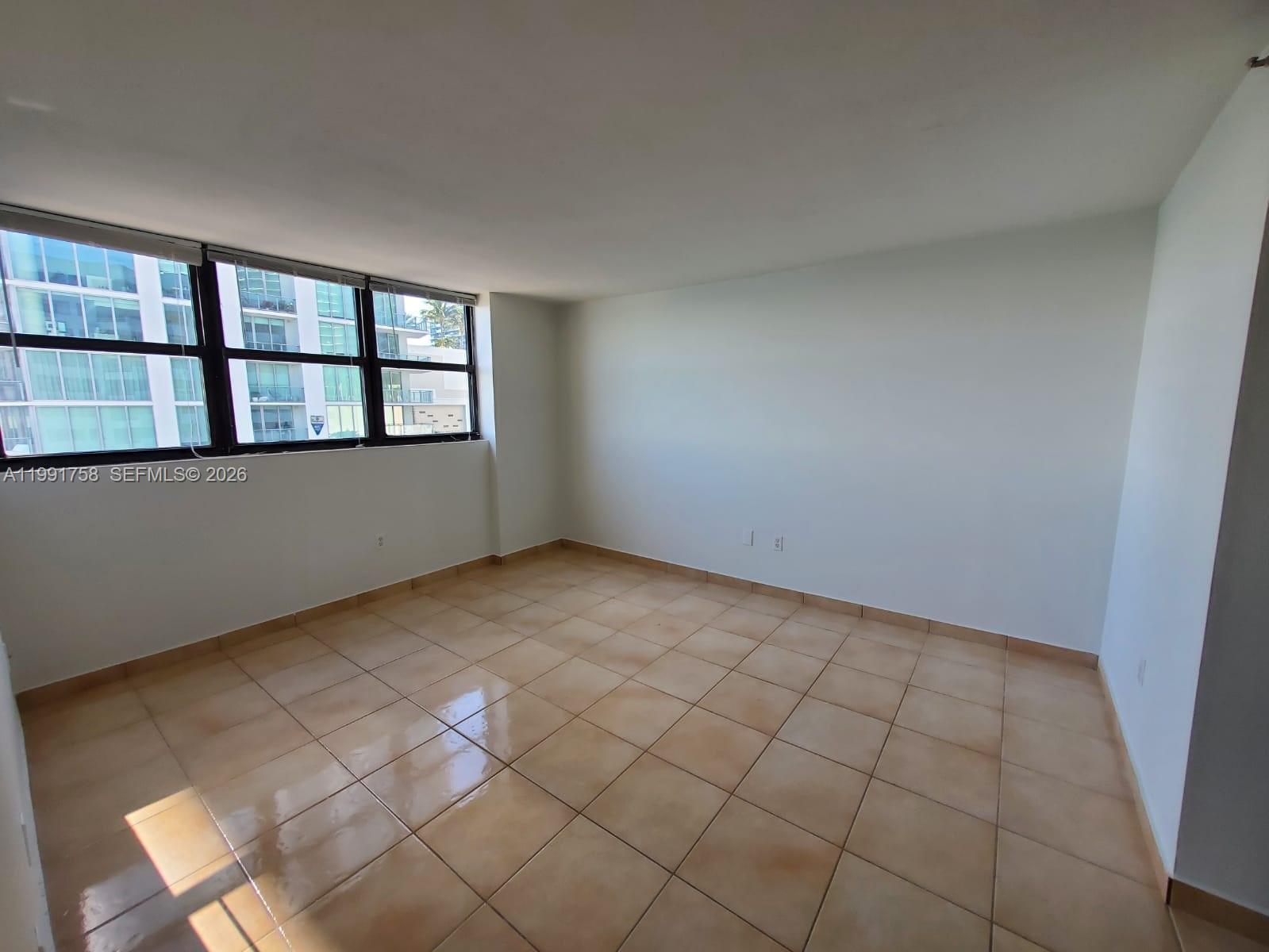 555 Northeast 30th Street, Unit 502 Miami, FL 33137 - Photo 9 of 19 an empty room with windows