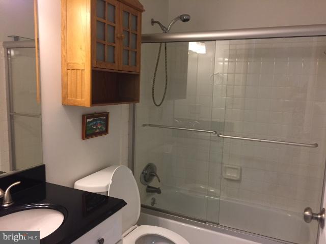10320 Apple Ridge Road Gaithersburg, MD 20886 - Photo 14 of 30 a bathroom with a granite countertop sink toilet a mirror and shower