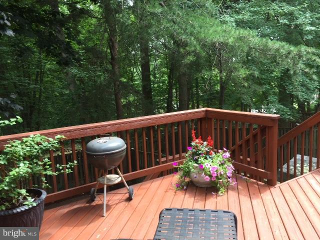 10320 Apple Ridge Road Gaithersburg, MD 20886 - Photo 18 of 30 a view of balcony with wooden floor and outdoor seating