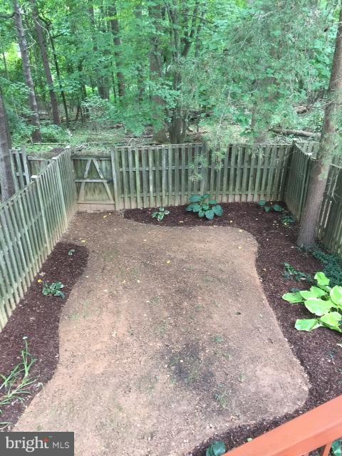 10320 Apple Ridge Road Gaithersburg, MD 20886 - Photo 20 of 30 a view of a yard with a wooden fence