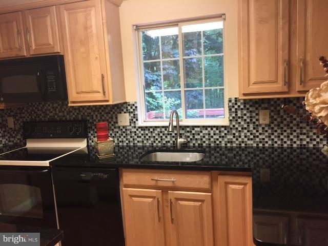 10320 Apple Ridge Road Gaithersburg, MD 20886 - Photo 9 of 30 a kitchen with a sink and cabinets