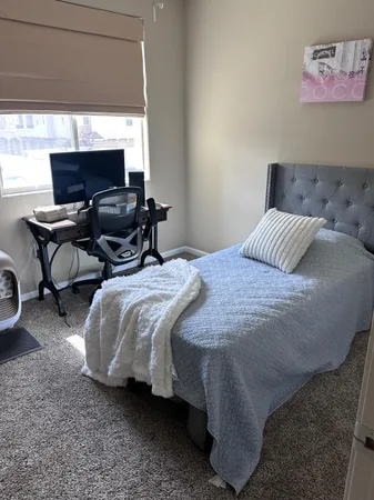 a bedroom with a bed and chair