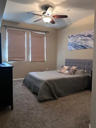 a bedroom with a bed and a window