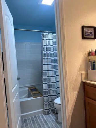 a kitchen with refrigerator and cabinets