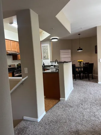 a kitchen with a sink a counter top space cabinets and stainless steel appliances