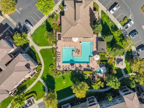 a view of a house with garden and a car porch