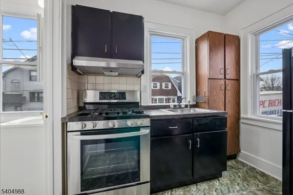 a kitchen with stainless steel appliances granite countertop a stove and a refrigerator