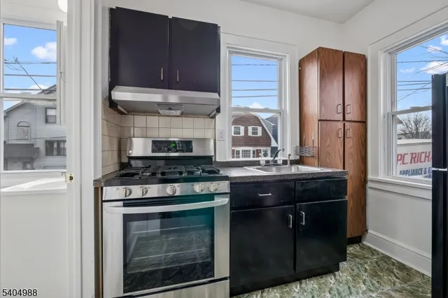 a kitchen with stainless steel appliances granite countertop a stove and a refrigerator