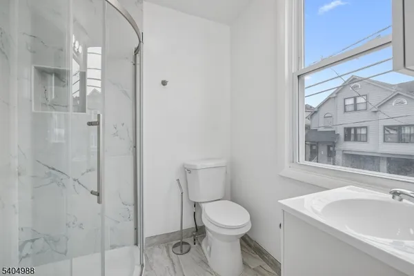 a white toilet sitting next to a bathroom sink