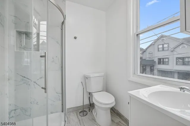 a white toilet sitting next to a bathroom sink
