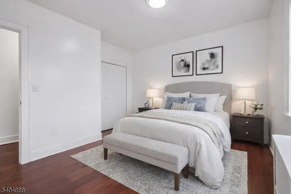 a bedroom with a bed and a lamp on the table