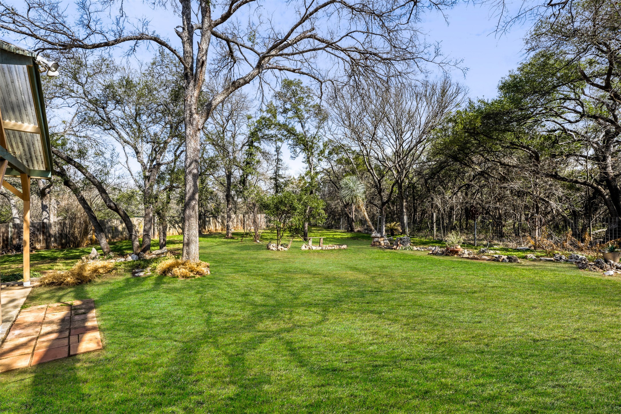 6701 Stage Coach Trail Austin, TX 78745 - Photo 20 of 23 View of green lawn featuring view of wooded area