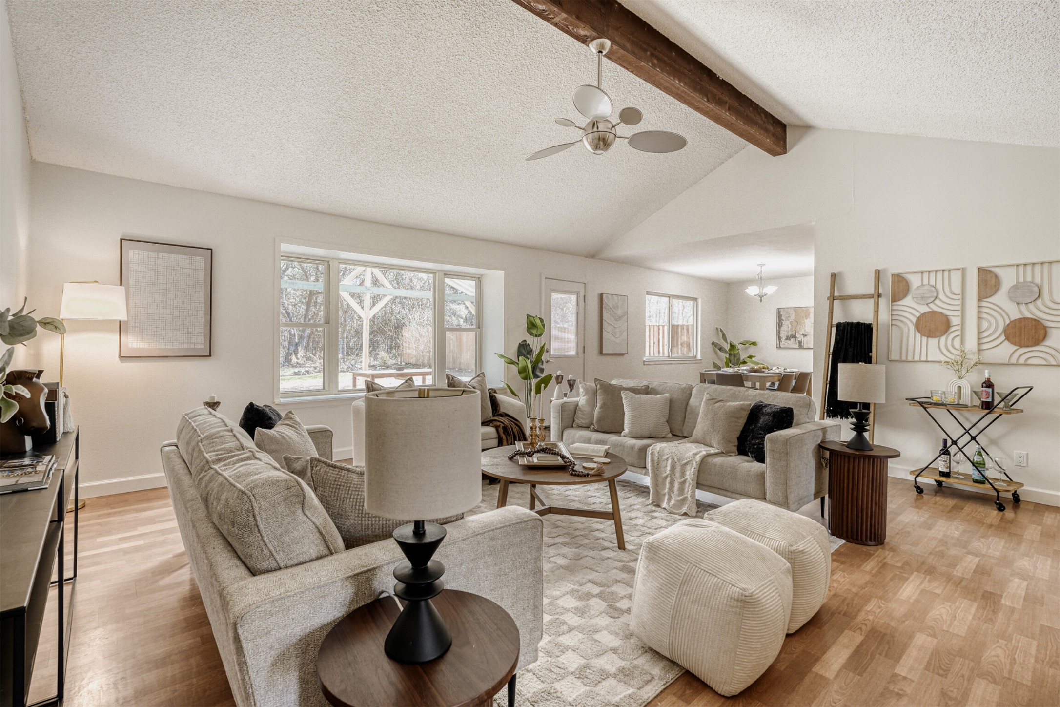 6701 Stage Coach Trail Austin, TX 78745 - Photo 2 of 23 Living room with a textured ceiling, ceiling fan, light wood-style floors, and beamed ceiling