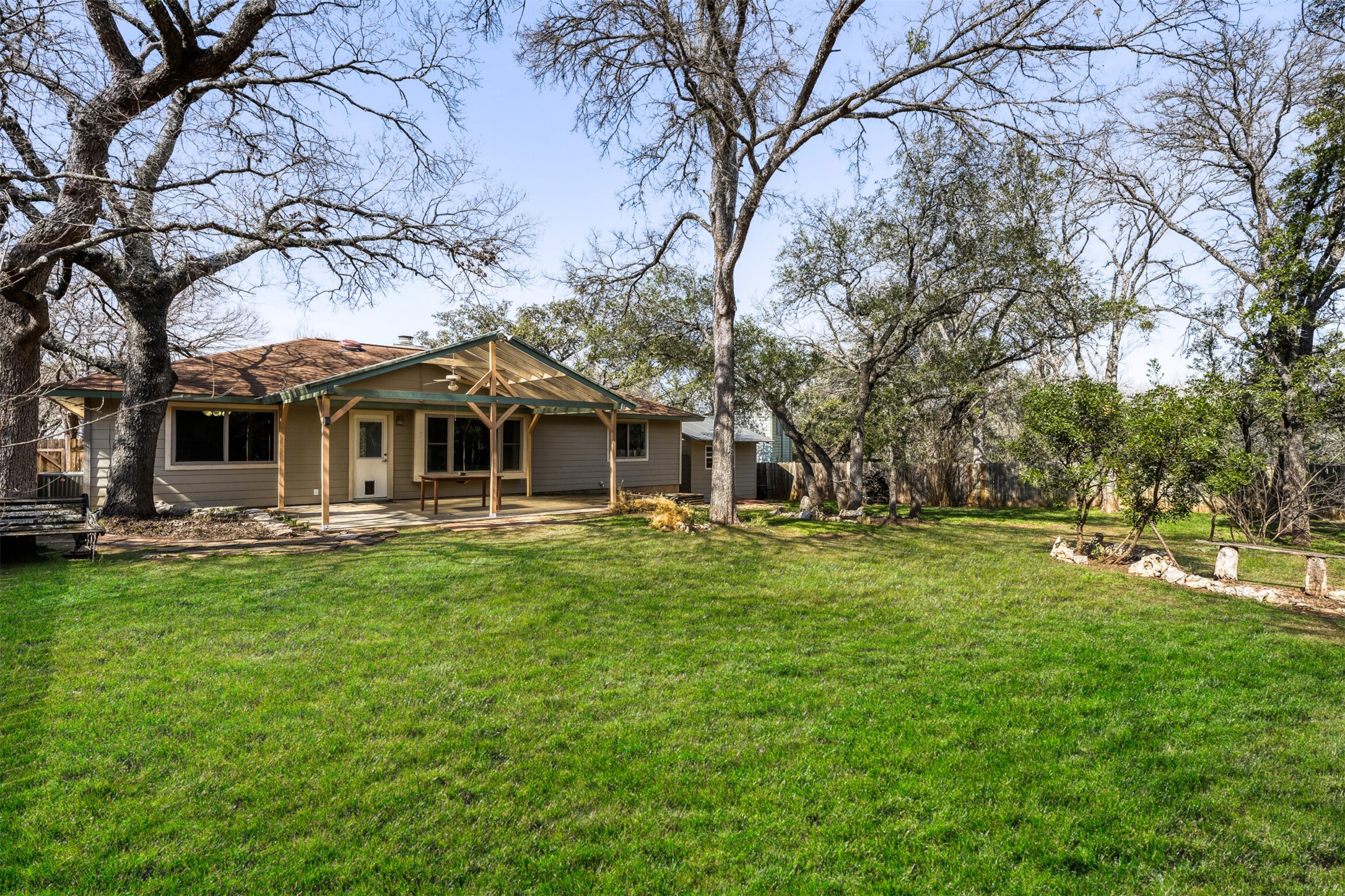 6701 Stage Coach Trail Austin, TX 78745 - Photo 21 of 23 Rear view of property featuring a yard and a patio area