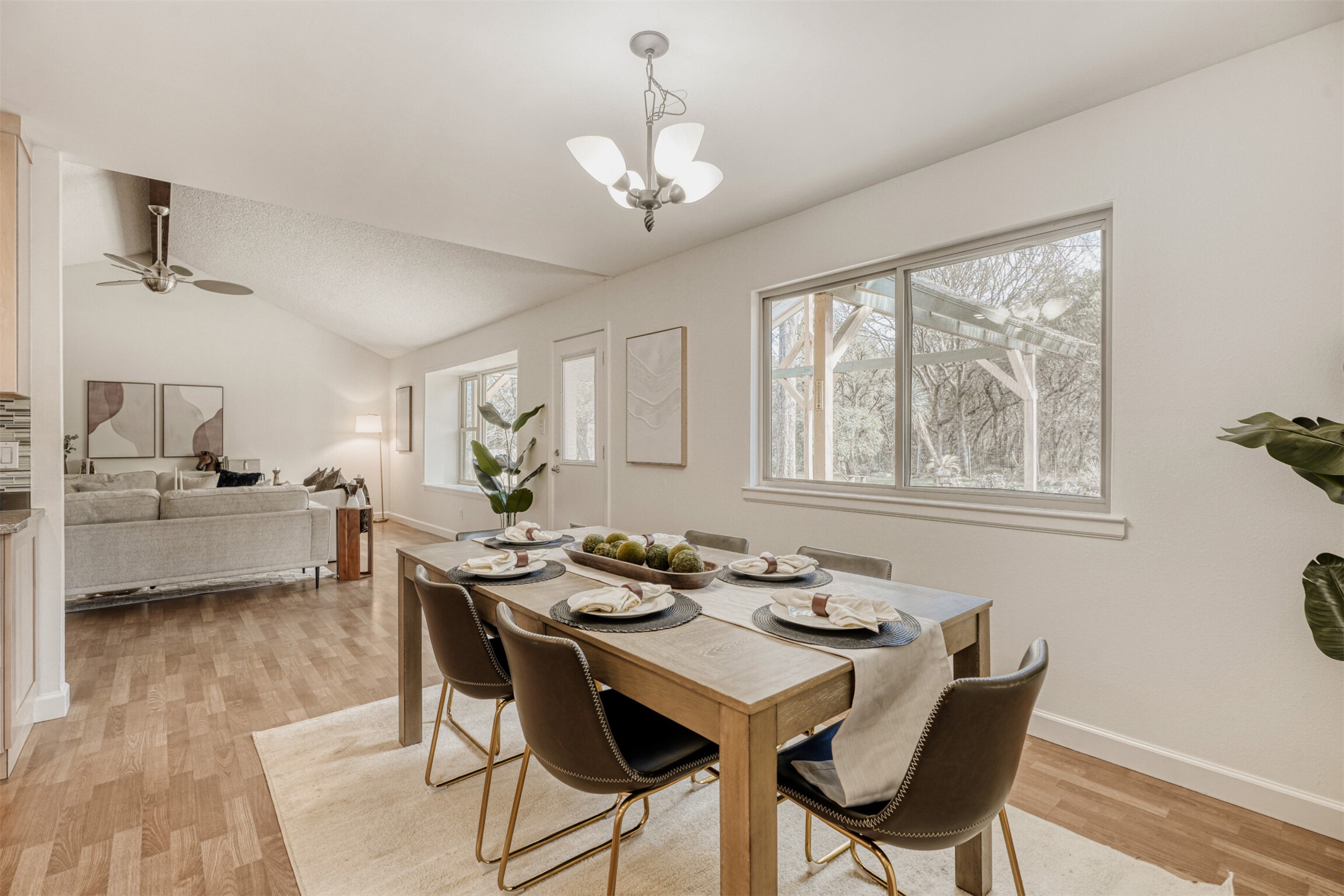 6701 Stage Coach Trail Austin, TX 78745 - Photo 7 of 23 Dining room with light wood finished floors, vaulted ceiling, suspended lighting, and a ceiling fan