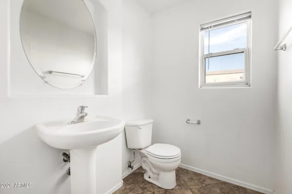 an empty room with a window and a ceiling fan