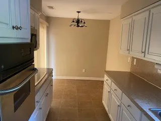 a kitchen with granite countertop a refrigerator and a stove