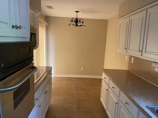 1500 Forest Avenue Columbus, GA 31906 - Photo 3 of 15 a kitchen with granite countertop a refrigerator and a stove