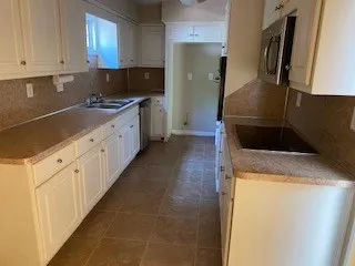 a kitchen with stainless steel appliances a refrigerator sink and stove