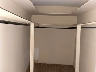 a view of walk in closet with empty racks