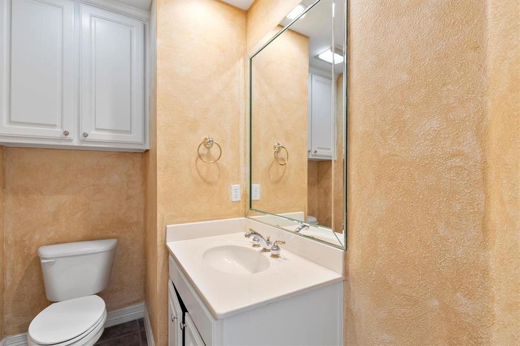 4106 Oberlin Way Addison, TX 75001 - Photo 7 of 17 a bathroom with a toilet sink and mirror