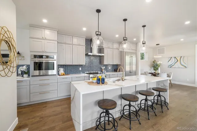 a bathroom with a granite countertop sink a toilet and mirror