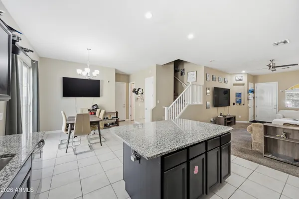 a kitchen with stainless steel appliances granite countertop a refrigerator stove top oven and sink