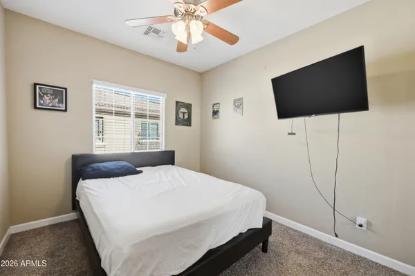 a bedroom with a bed and a couch