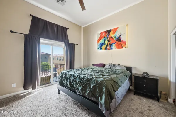 a bedroom with a bed and a painting on the wall