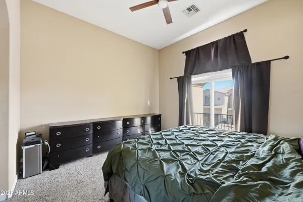 a bedroom with a bed and a window