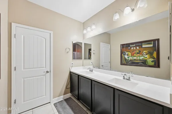 a bathroom with 2 sink and a mirror