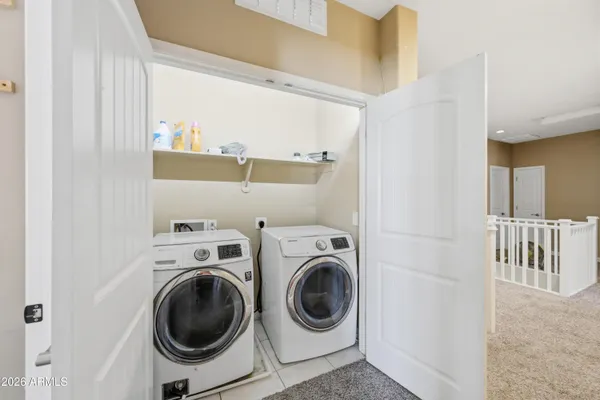 a view of storage and utility room with washer and dryer
