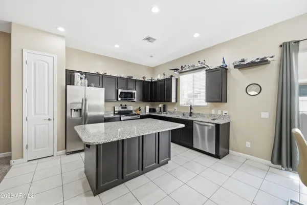 a living room with furniture and a view of kitchen