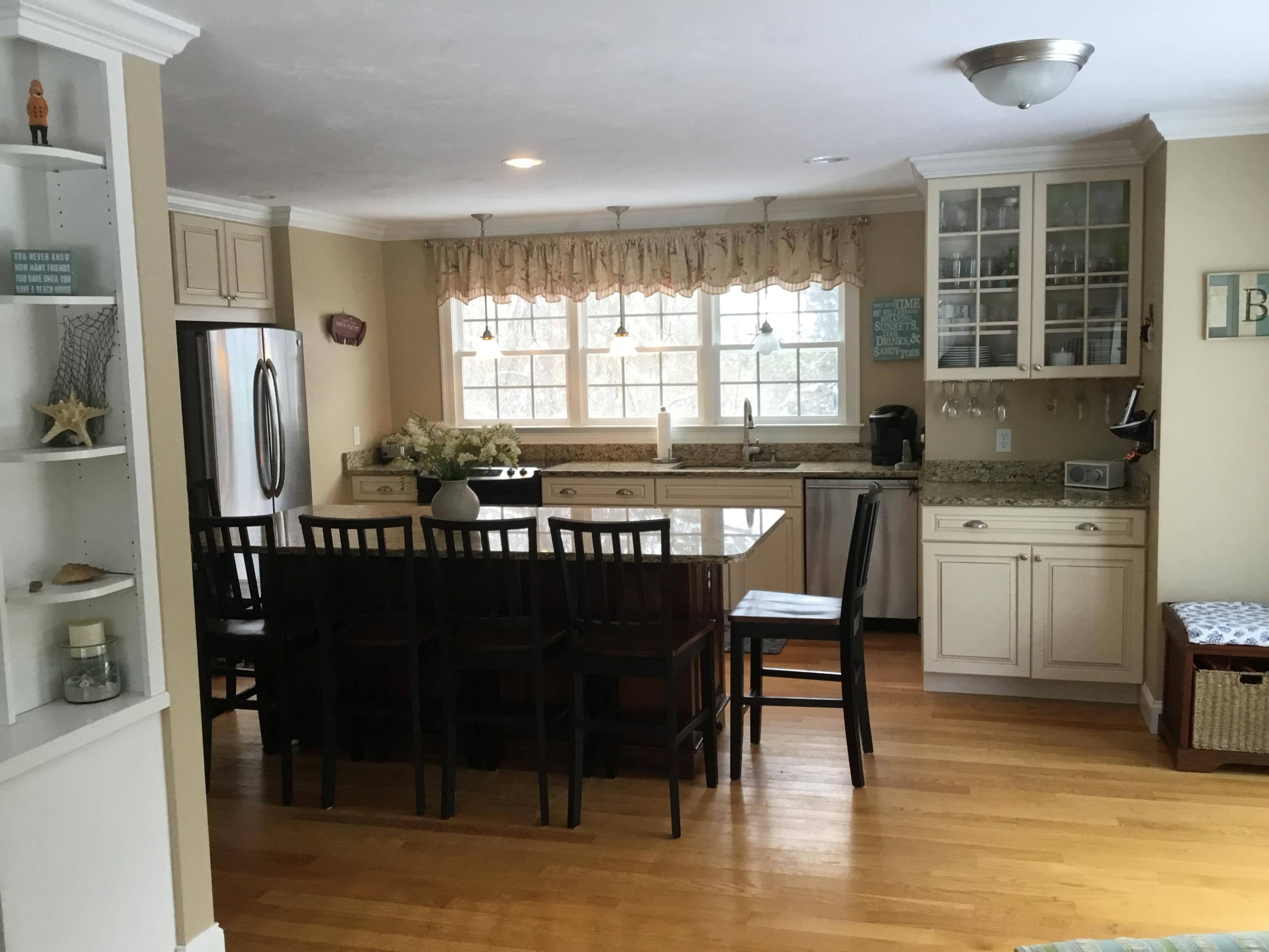 23 Torrey Road East Sandwich, MA 02537 - Photo 7 of 25 a kitchen with stainless steel appliances granite countertop a dining table chairs refrigerator and sink