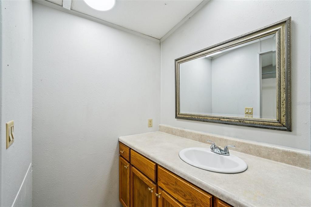 4708 Gallagher Road Plant City, FL 33565 - Photo 30 of 62 a bathroom with a granite countertop sink and a mirror
