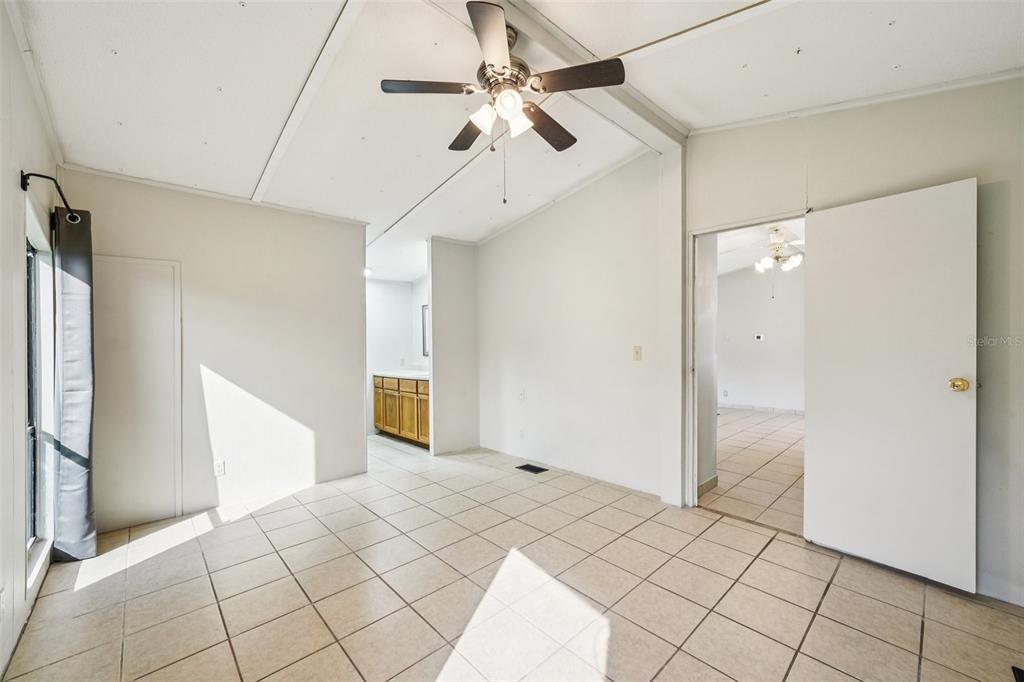 4708 Gallagher Road Plant City, FL 33565 - Photo 34 of 62 a bedroom with a bed and a ceiling fan