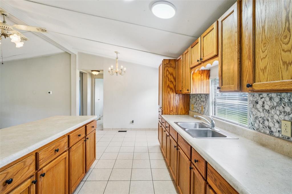 4708 Gallagher Road Plant City, FL 33565 - Photo 45 of 62 a kitchen with a sink stove and cabinets