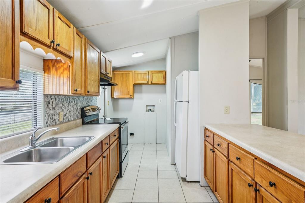 4708 Gallagher Road Plant City, FL 33565 - Photo 48 of 62 a kitchen with a sink stove and refrigerator