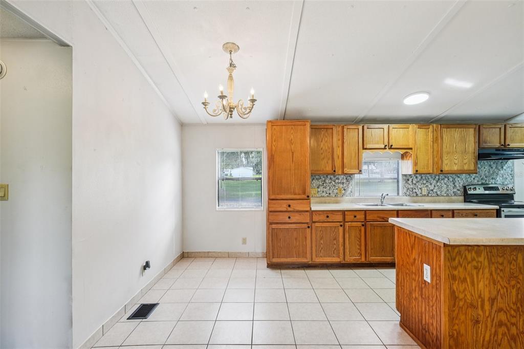 4708 Gallagher Road Plant City, FL 33565 - Photo 52 of 62 a kitchen with stainless steel appliances granite countertop a sink and cabinets
