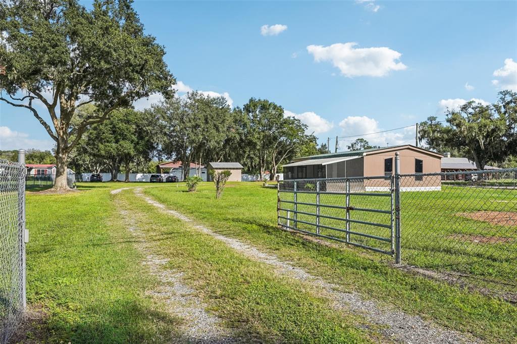 4708 Gallagher Road Plant City, FL 33565 - Photo 60 of 62 a view of a house with a yard