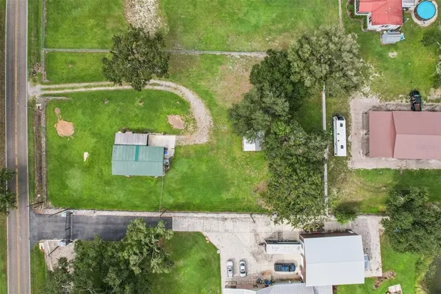 an aerial view of a house with a garden and yard