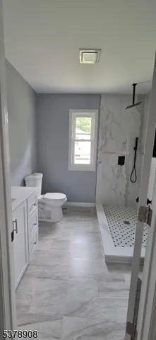 a bathroom with a shower and a mirror